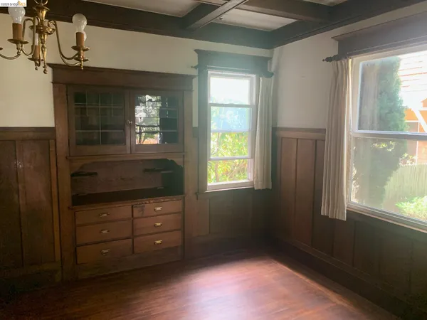 a room with a dresser and a window