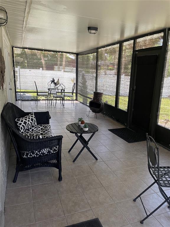 575 Tiberon Cove Road Longwood, FL 32750 - Photo 43 of 56 a living room with furniture and a floor to ceiling window