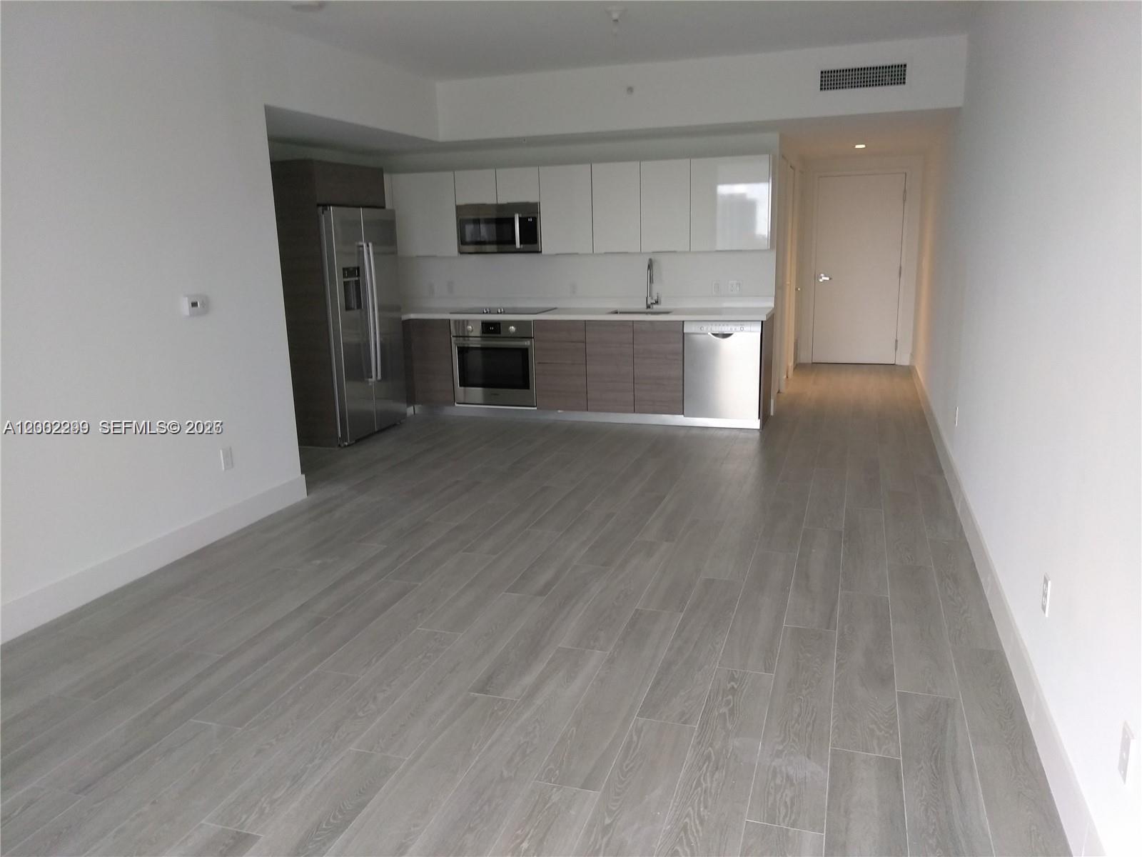 1010 Southwest 2nd Avenue, Unit 1901 Miami, FL 33130 - Photo 6 of 8 a view of a kitchen with a sink and a refrigerator