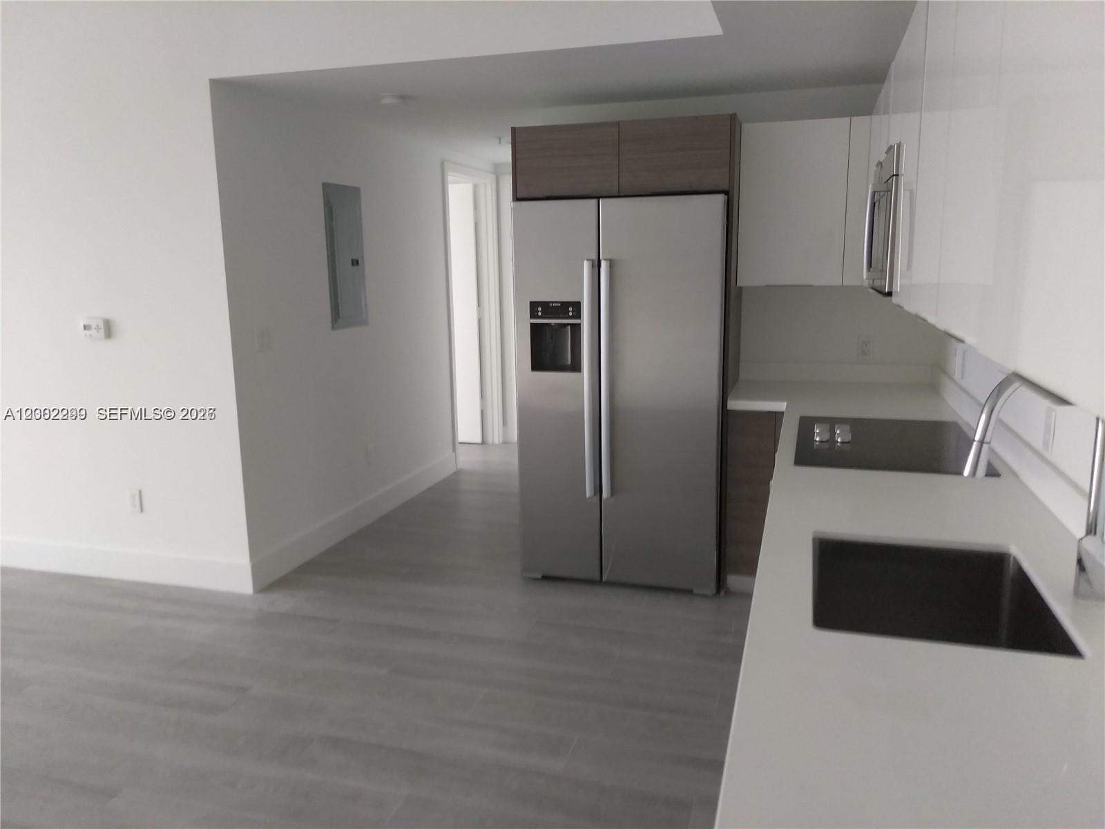 1010 Southwest 2nd Avenue, Unit 1901 Miami, FL 33130 - Photo 8 of 8 a kitchen with a refrigerator and a sink