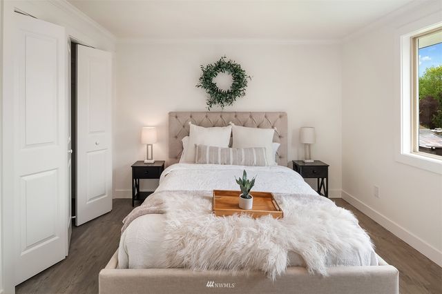 a bed sitting in a bedroom next to a window