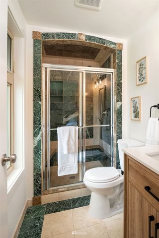 a bathroom with a toilet a sink and a shower