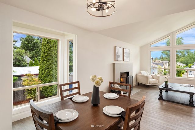 a view of a dining room with furniture large windows and wooden floor