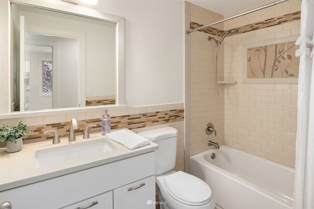 a bathroom with a sink toilet tub and shower