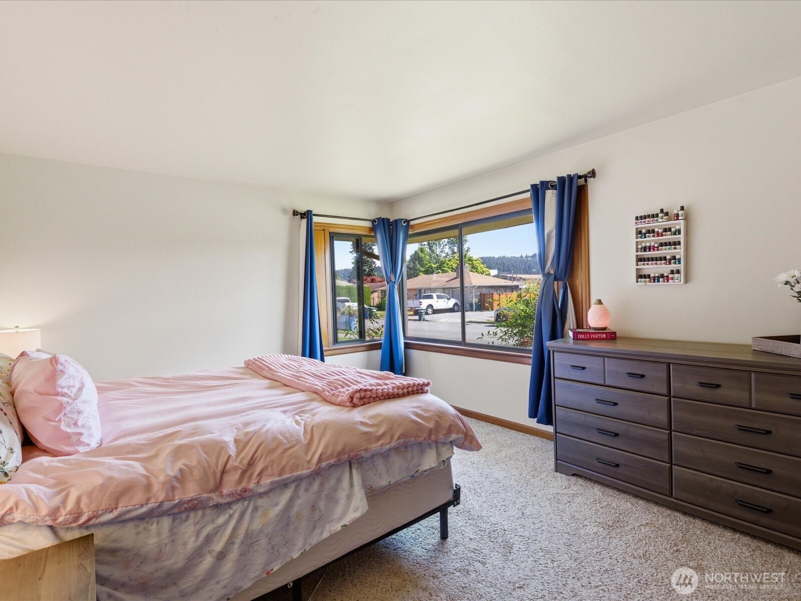 1417 Maple Street Sumner, WA 98390 - Photo 14 of 40 a bedroom with a bed and a dresser next to a window
