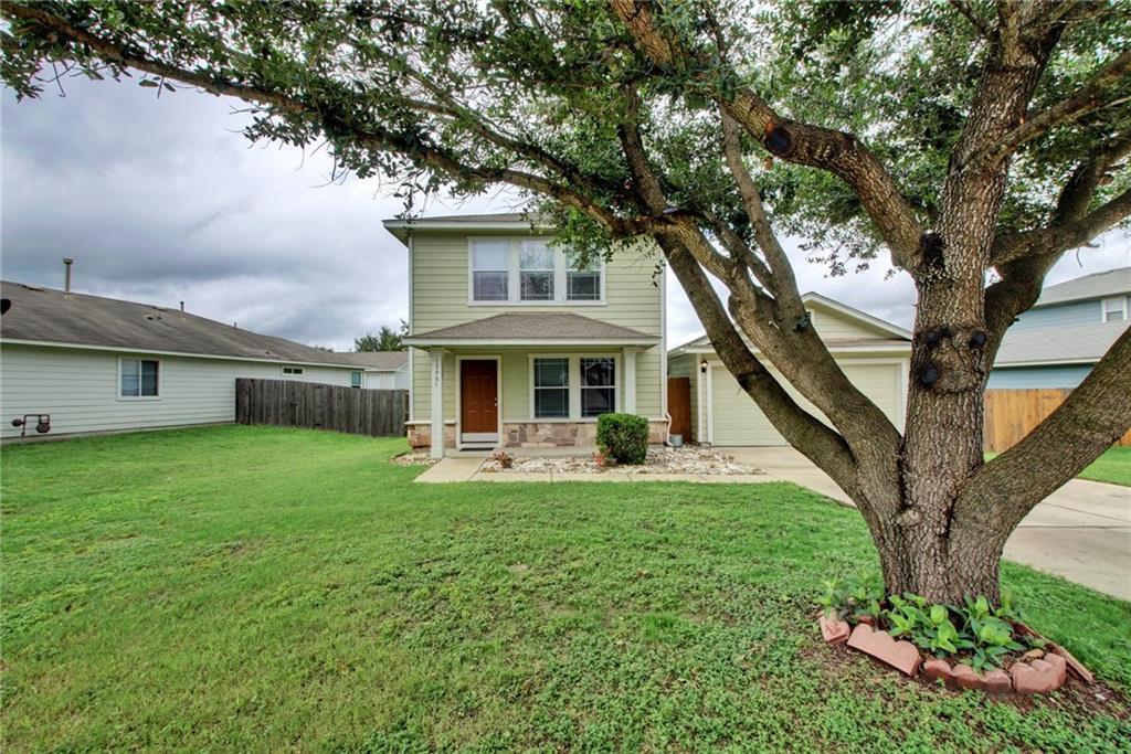 13905 Briarcreek Loop Manor, TX 78653 - Photo 1 of 25 View of front facade with a garage, stone siding, concrete driveway, and a porch