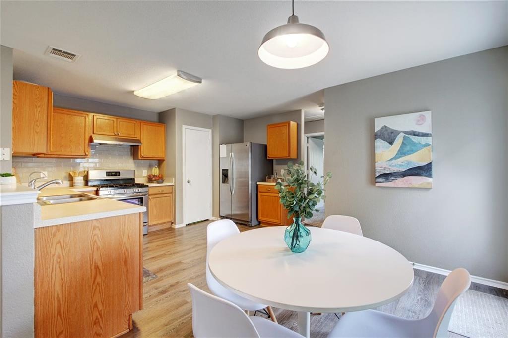 13905 Briarcreek Loop Manor, TX 78653 - Photo 8 of 25 Dining room with light wood finished floors and baseboards
