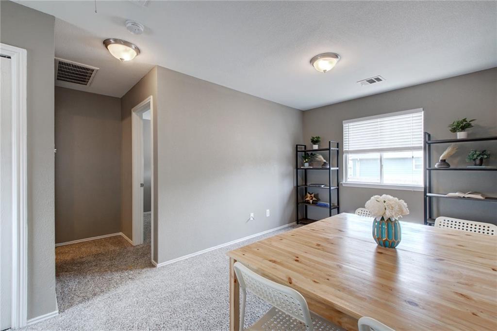 13905 Briarcreek Loop Manor, TX 78653 - Photo 11 of 25 Dining area with light carpet and baseboards