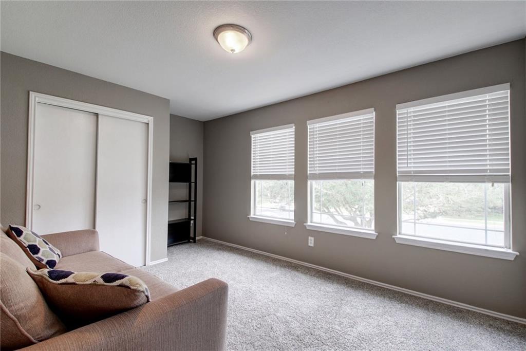 13905 Briarcreek Loop Manor, TX 78653 - Photo 13 of 25 Living area with carpet flooring and baseboards
