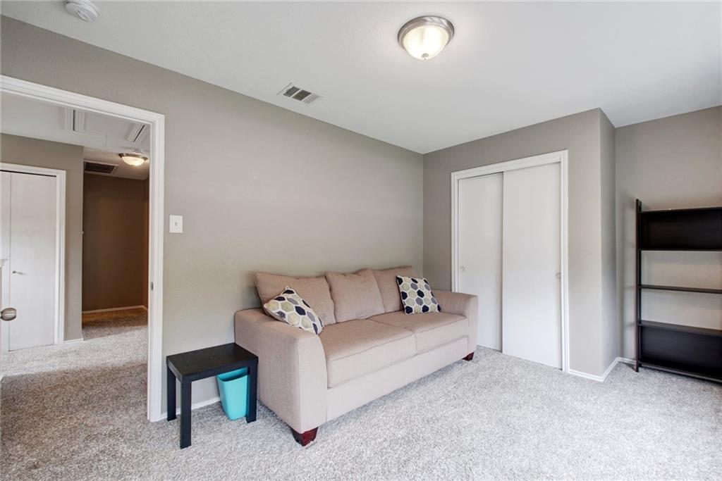 13905 Briarcreek Loop Manor, TX 78653 - Photo 14 of 25 Living area with light colored carpet and baseboards