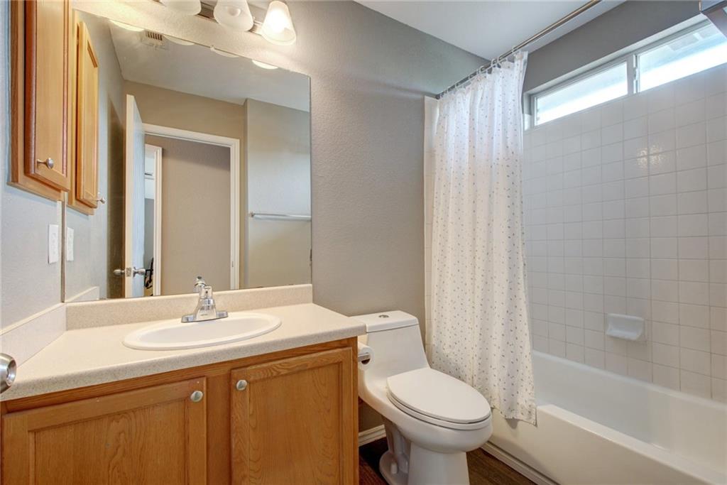 13905 Briarcreek Loop Manor, TX 78653 - Photo 15 of 25 Full bathroom featuring shower / bath combo with shower curtain and vanity