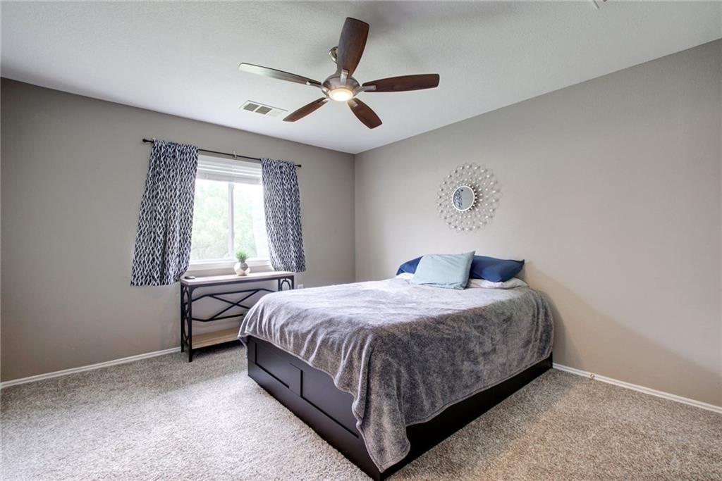 13905 Briarcreek Loop Manor, TX 78653 - Photo 18 of 25 Bedroom with a ceiling fan and light colored carpet