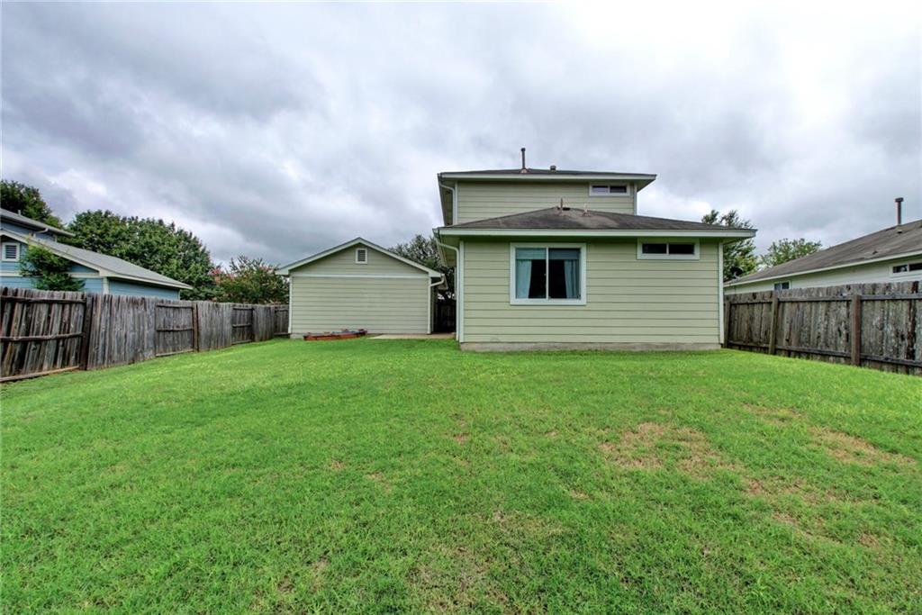13905 Briarcreek Loop Manor, TX 78653 - Photo 21 of 25 Back of house with a fenced backyard