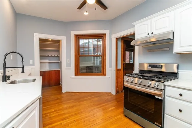 a kitchen with stainless steel appliances a stove a sink and a microwave