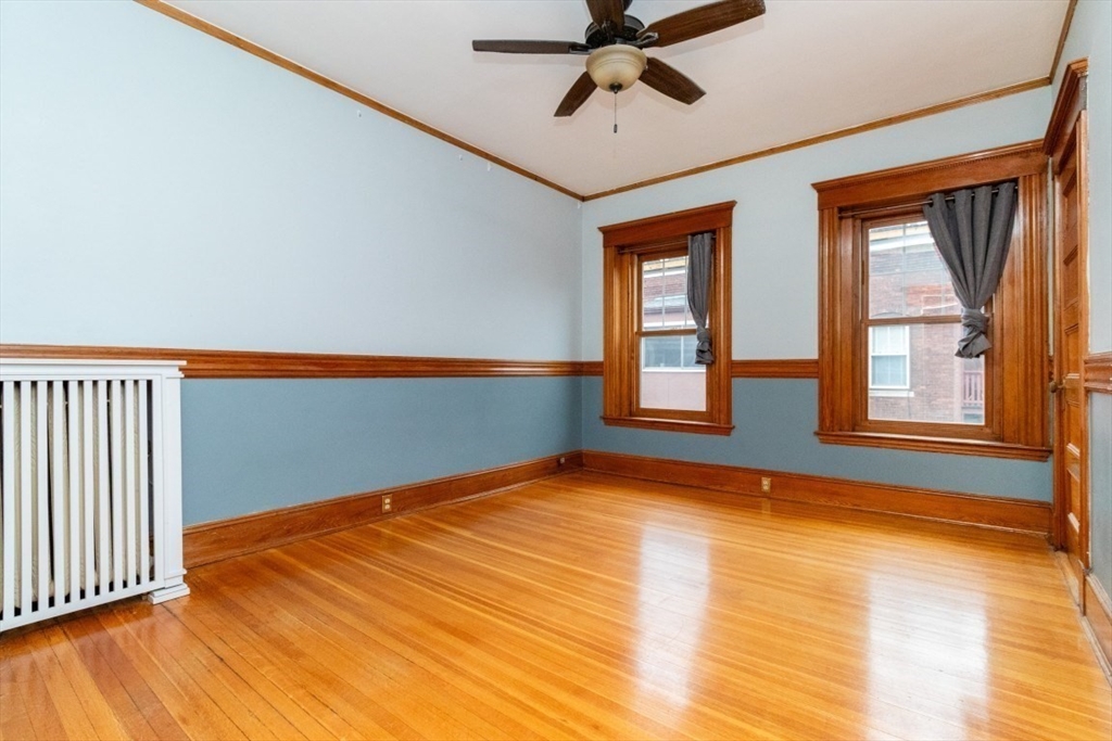 12 Pond Street, Unit 3 Boston, MA 02130 - Photo 21 of 39 a view of an empty room with window and wooden floor