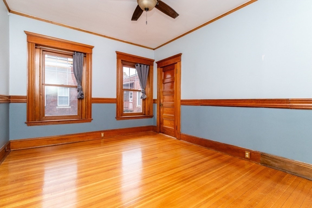 12 Pond Street, Unit 3 Boston, MA 02130 - Photo 22 of 39 a view of an empty room with window and wooden floor