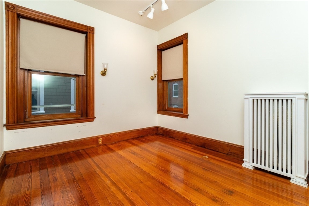 12 Pond Street, Unit 3 Boston, MA 02130 - Photo 28 of 39 an empty room with wooden floor and windows