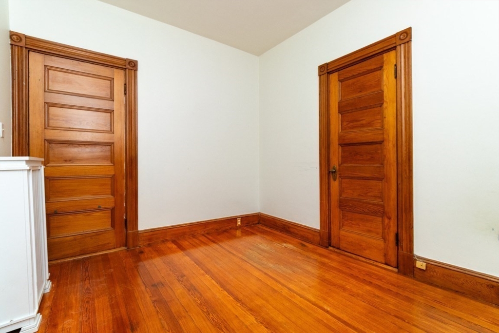 12 Pond Street, Unit 3 Boston, MA 02130 - Photo 30 of 39 an empty room with wooden floor and closet