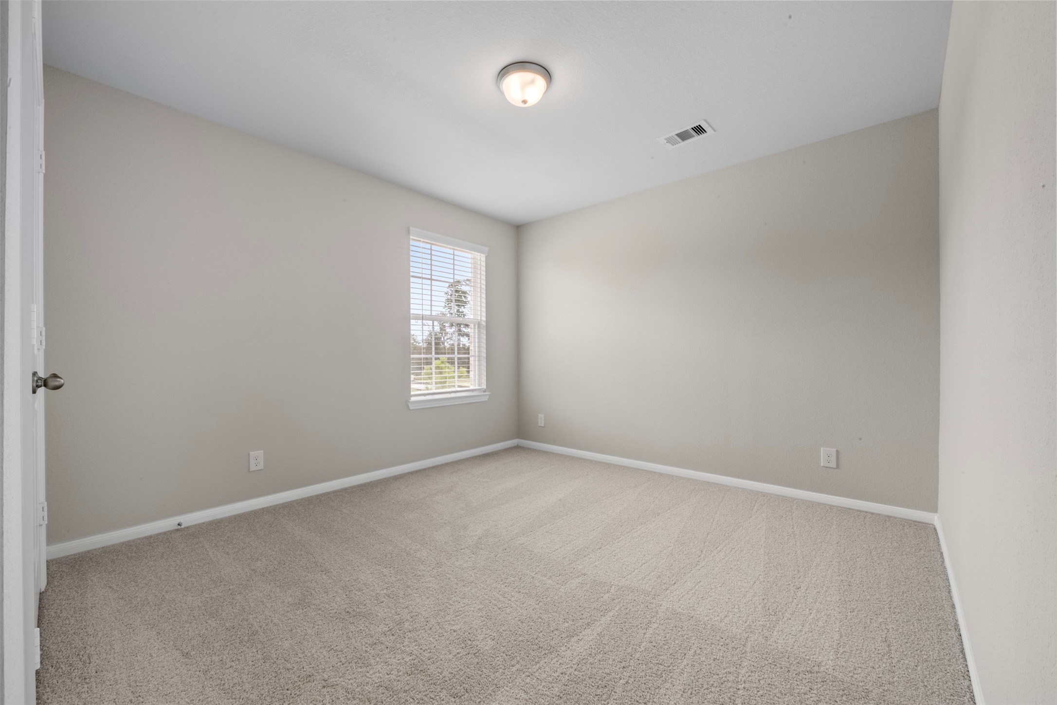 10783 Sora Drive Willis, TX 77378 - Photo 19 of 26 a view of an empty room with a window