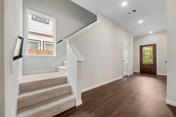 a view of entryway with wooden floor and stairs