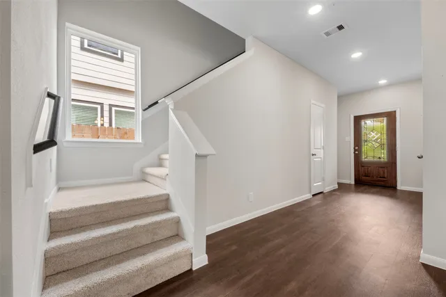 a view of entryway with wooden floor and stairs