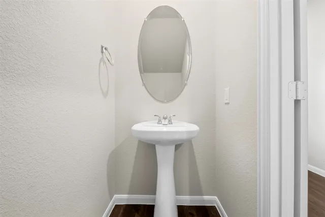 a bathroom with a sink a mirror and a toilet