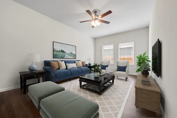 a living room with furniture potted plant and a window