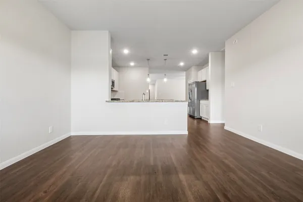 a view of a kitchen with a sink and wooden floor