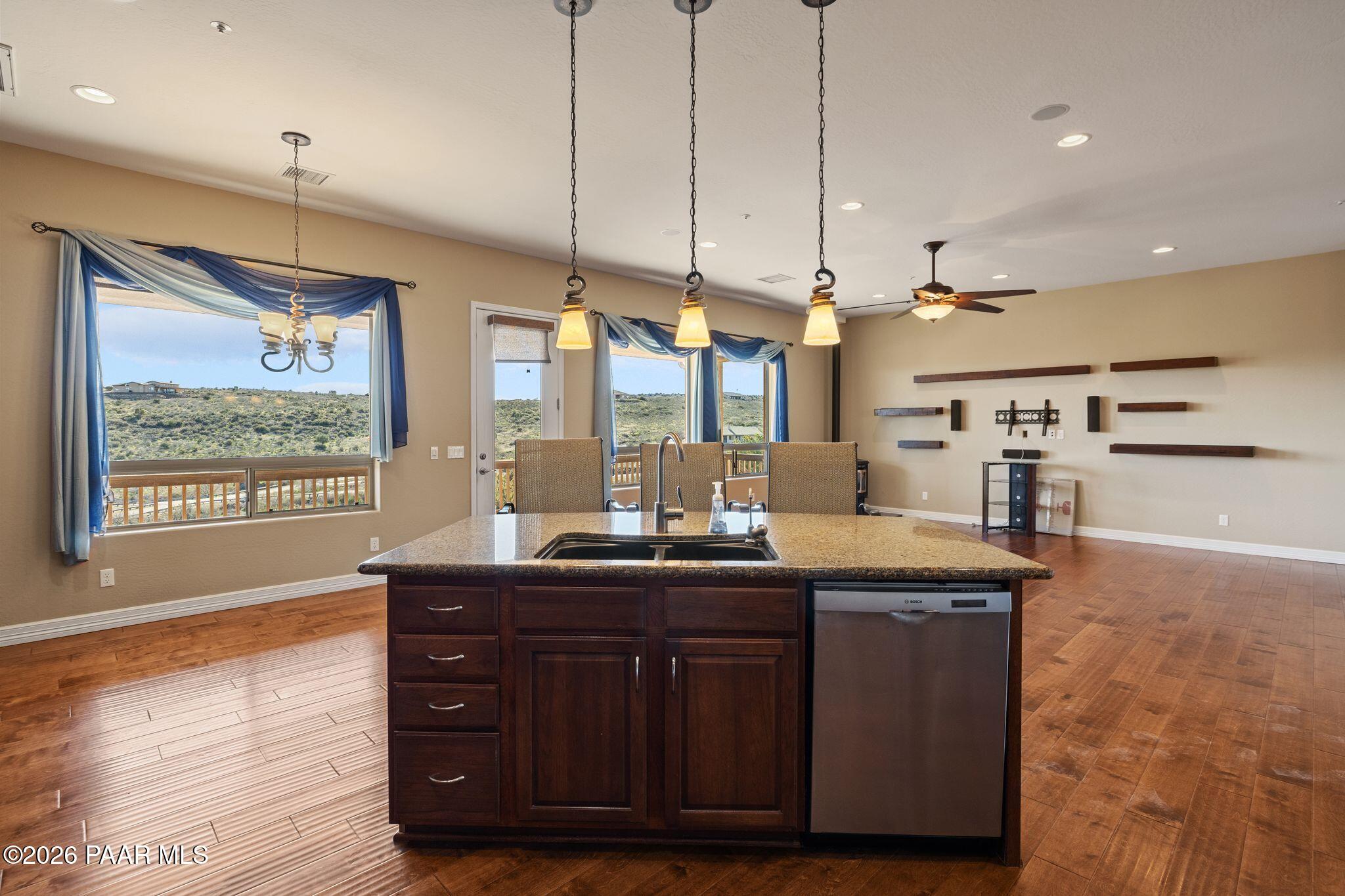 15411 East Rough Rider Ridge Mayer, AZ 86333 - Photo 13 of 57 a kitchen with a stove a counter space a large window and furniture