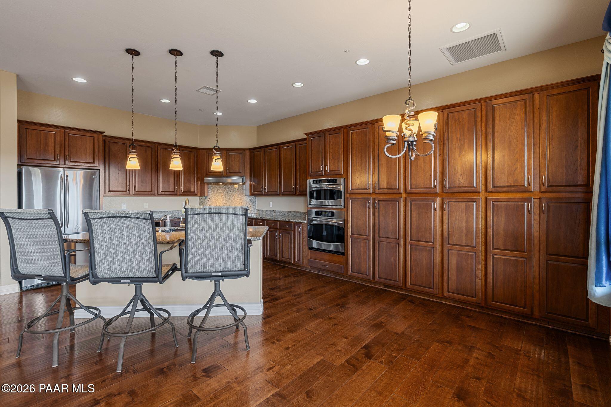 15411 East Rough Rider Ridge Mayer, AZ 86333 - Photo 15 of 57 a large kitchen with a table and chairs