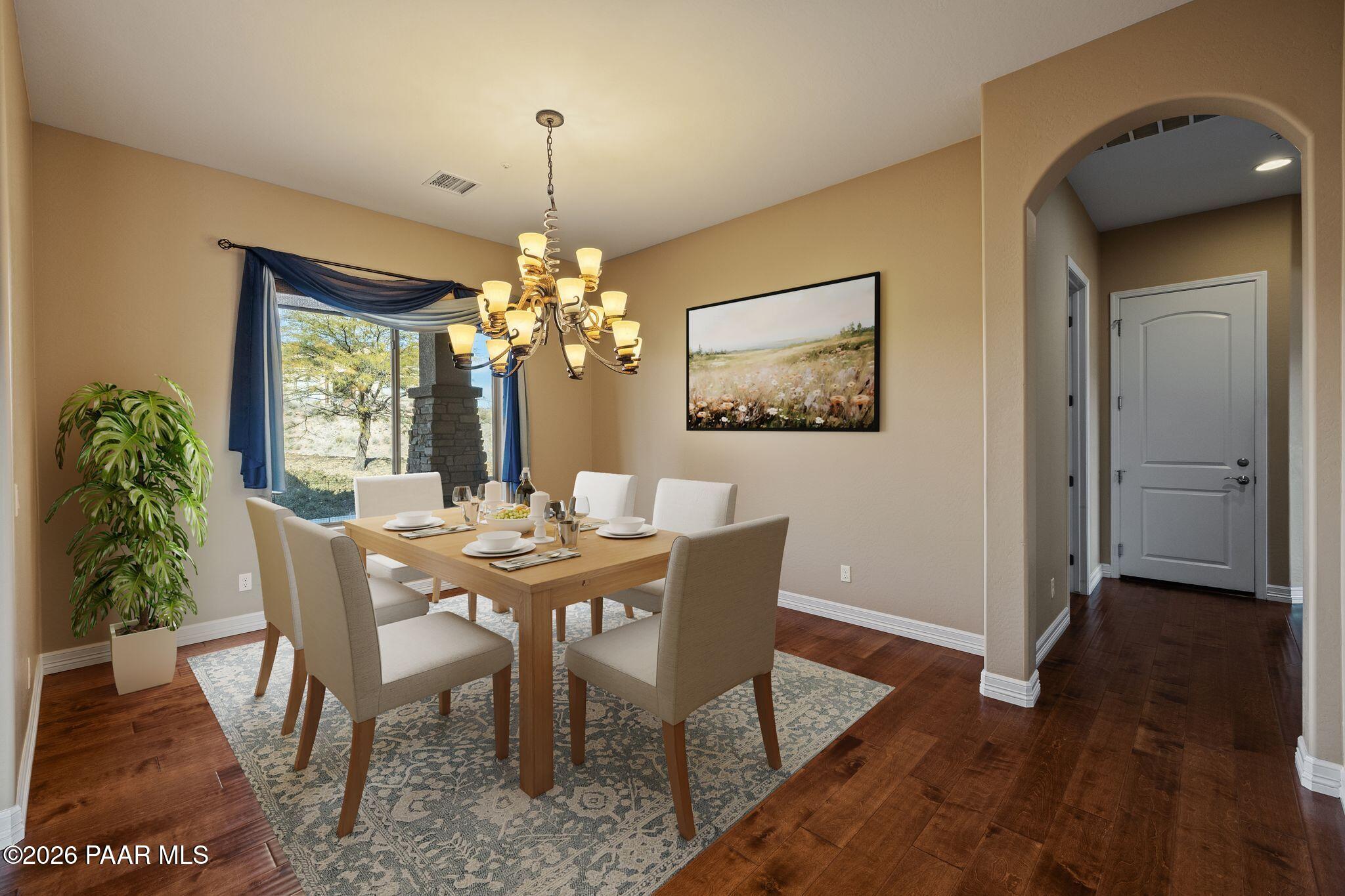15411 East Rough Rider Ridge Mayer, AZ 86333 - Photo 20 of 57 a dining room with furniture a chandelier and wooden floor