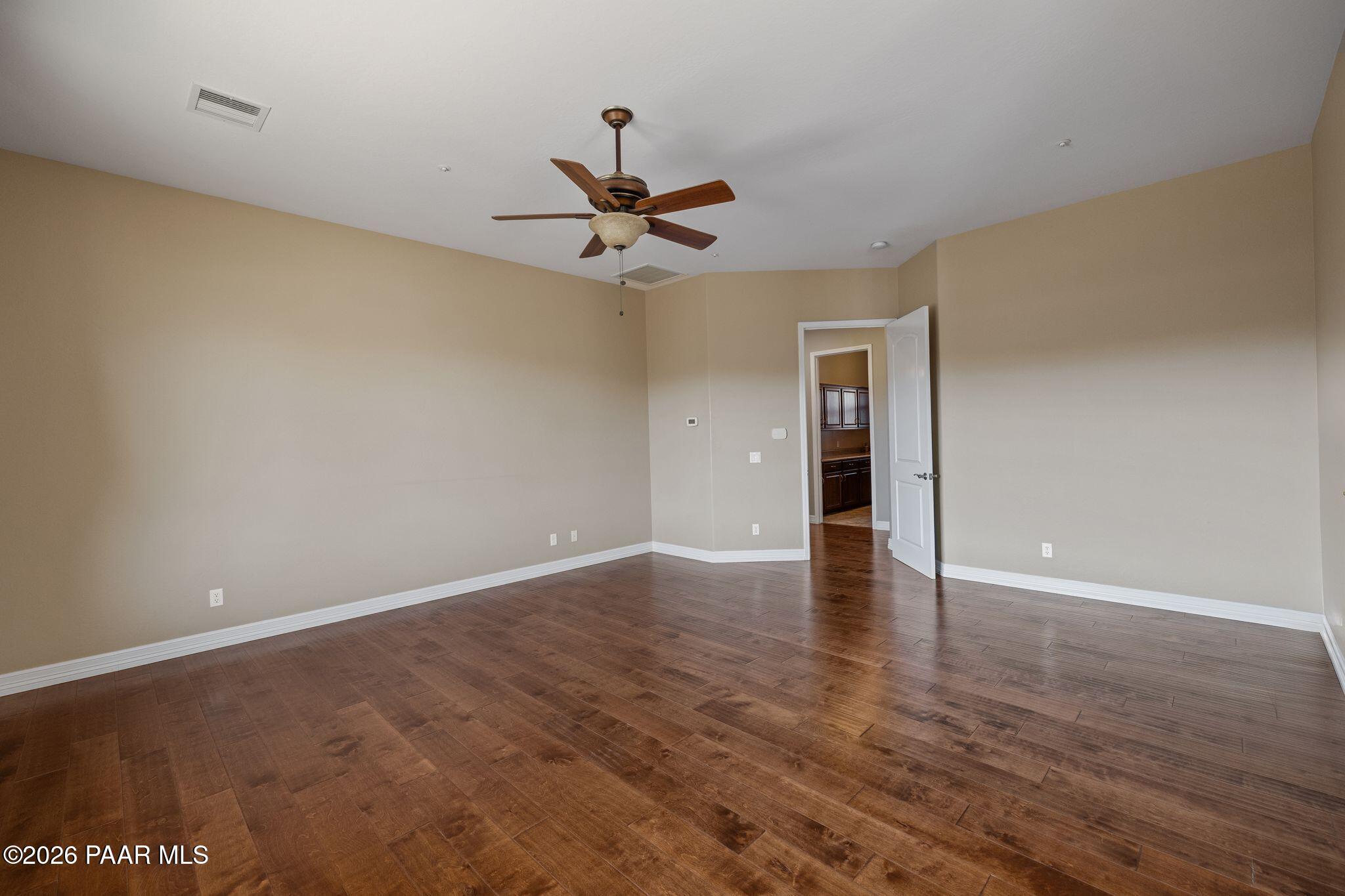 15411 East Rough Rider Ridge Mayer, AZ 86333 - Photo 24 of 57 a view of an empty room with window and wooden floor