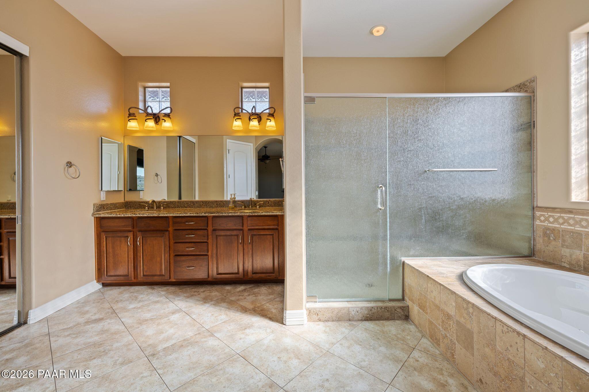 15411 East Rough Rider Ridge Mayer, AZ 86333 - Photo 25 of 57 a bathroom with a granite countertop sink a toilet and a bathtub