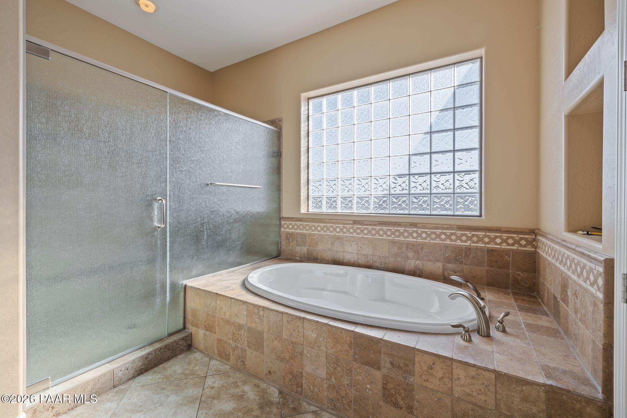 15411 East Rough Rider Ridge Mayer, AZ 86333 - Photo 26 of 57 a white bath tub sitting in a bathroom next to a window