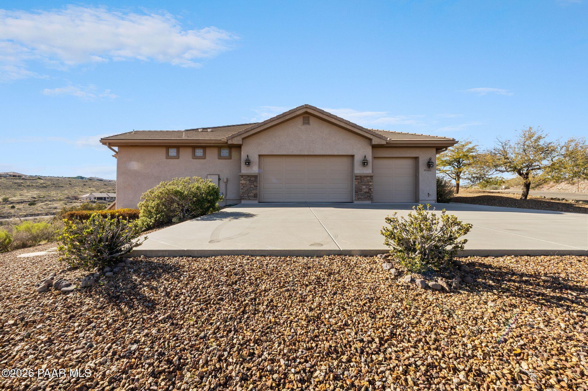15411 East Rough Rider Ridge Mayer, AZ 86333 - Photo 3 of 57 a front view of a house with a yard