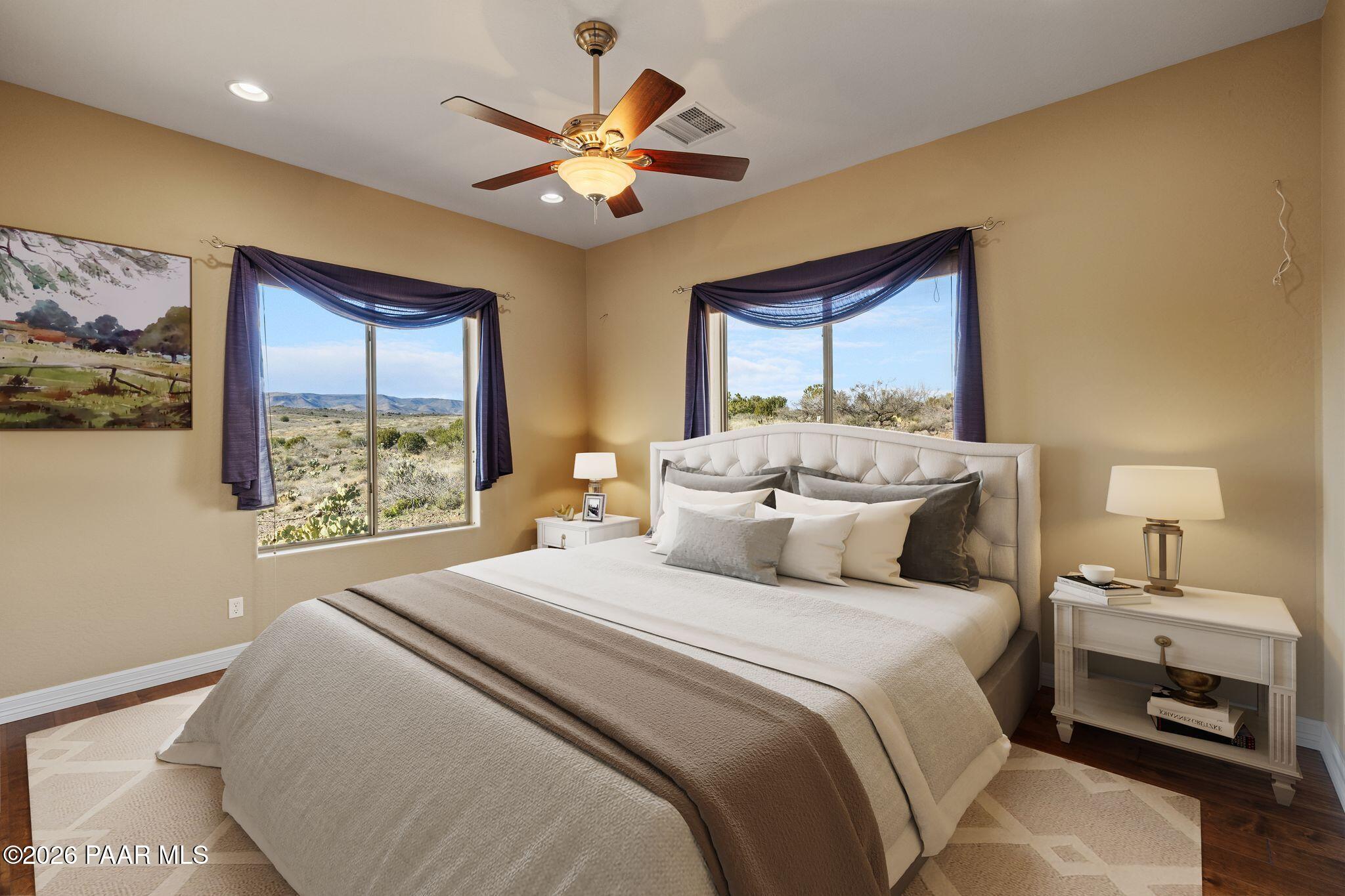 15411 East Rough Rider Ridge Mayer, AZ 86333 - Photo 31 of 57 a bedroom with a large bed and a chandelier