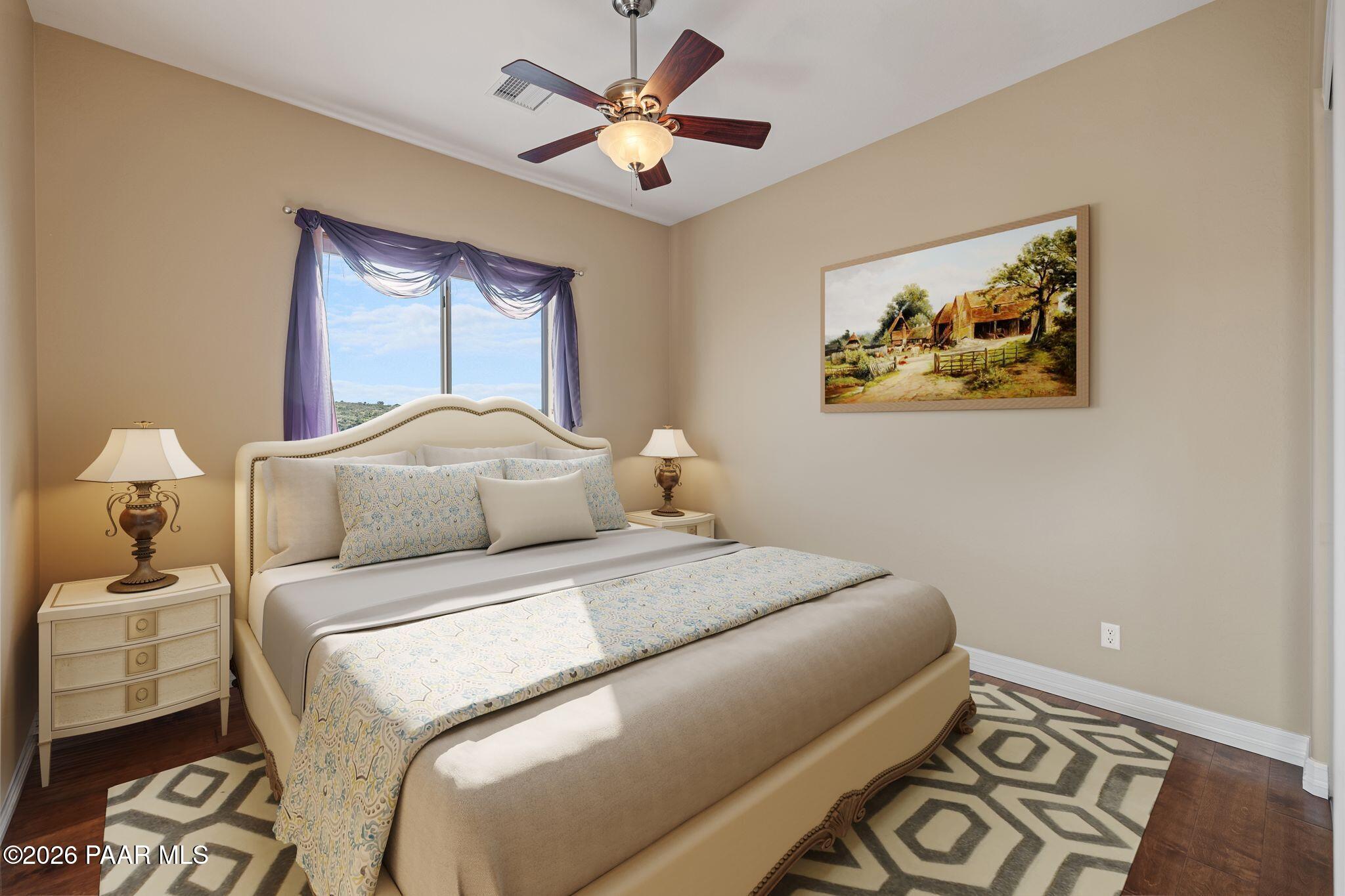 15411 East Rough Rider Ridge Mayer, AZ 86333 - Photo 37 of 57 a bedroom with a bed and a painting on the wall