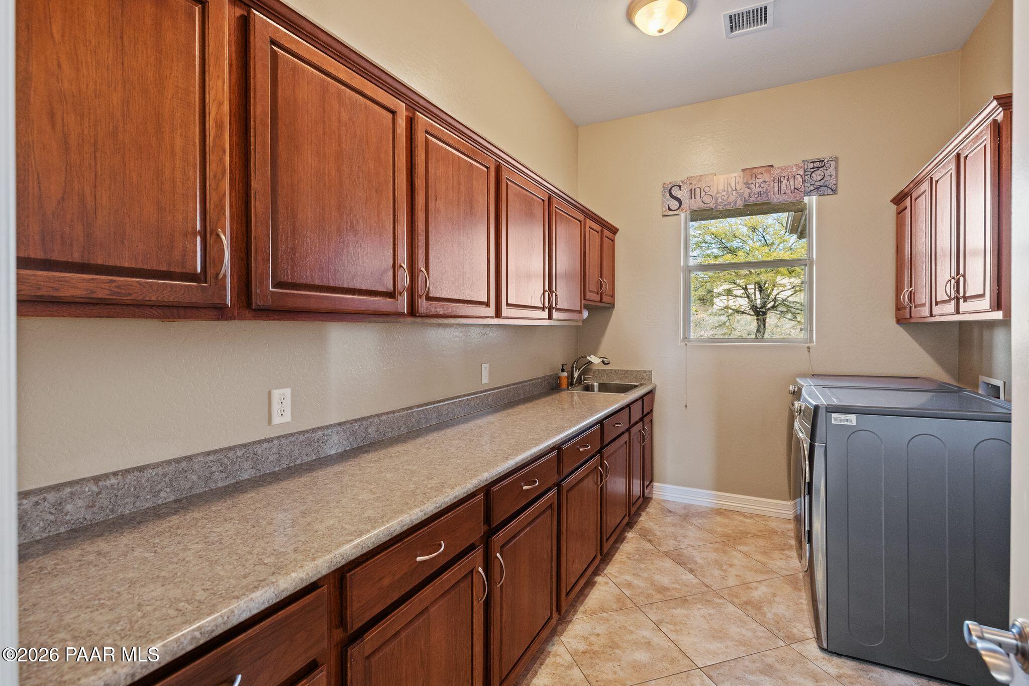 15411 East Rough Rider Ridge Mayer, AZ 86333 - Photo 39 of 57 a kitchen with granite countertop cabinets stainless steel appliances a sink and a counter top space