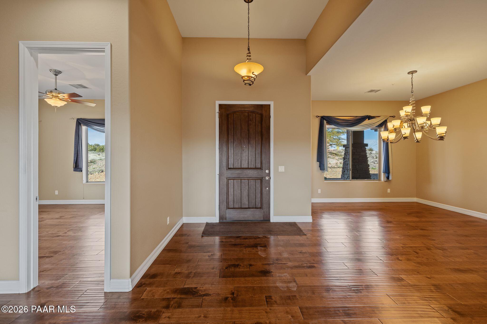 15411 East Rough Rider Ridge Mayer, AZ 86333 - Photo 5 of 57 a view of a hallway with wooden floor and a chandelier
