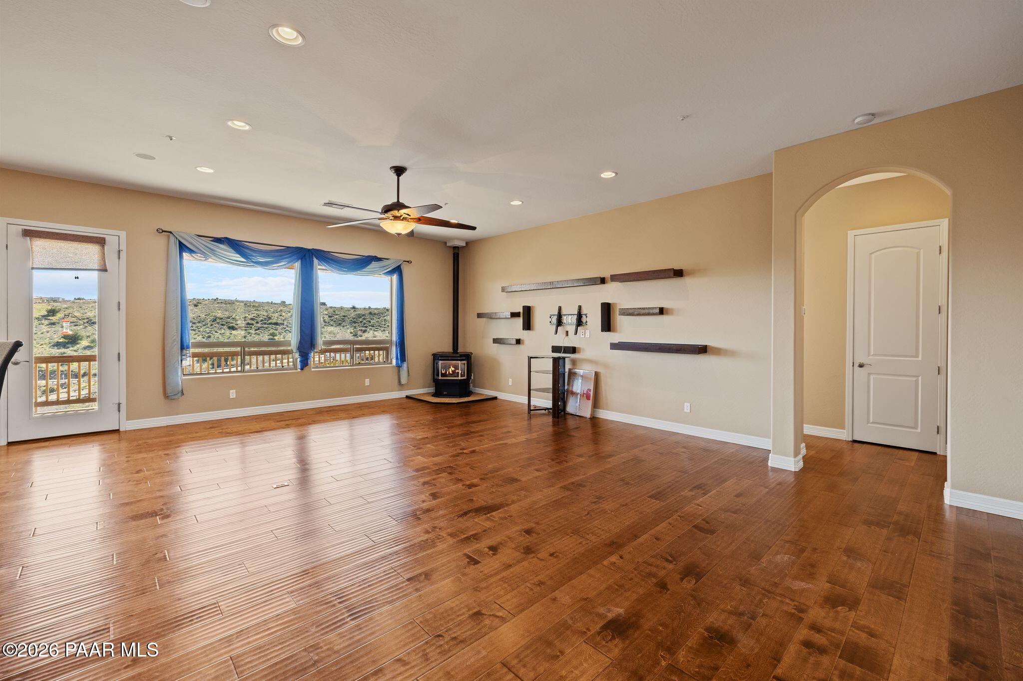 15411 East Rough Rider Ridge Mayer, AZ 86333 - Photo 6 of 57 a view of an empty room with a window and wooden floor
