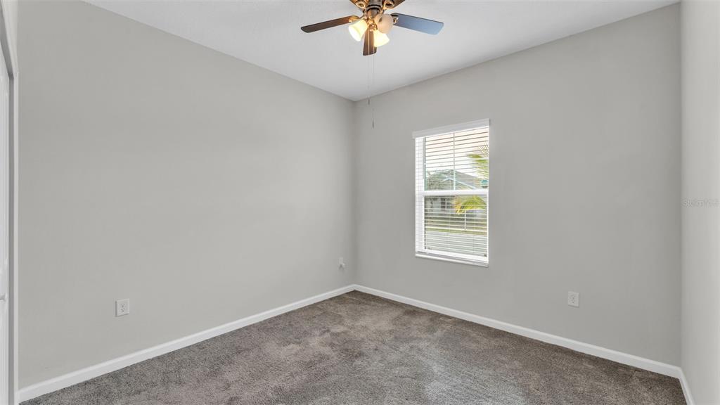 244 Pershing Street Bartow, FL 33830 - Photo 11 of 32 an empty room with a window and a ceiling fan