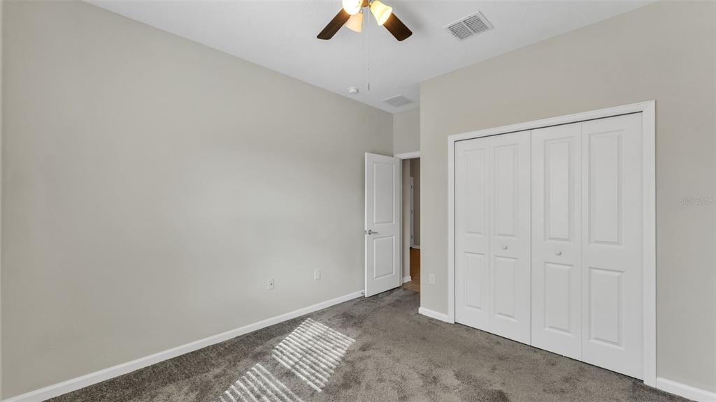244 Pershing Street Bartow, FL 33830 - Photo 12 of 32 an empty room with ceiling fan