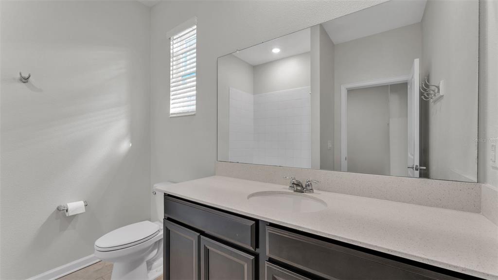 244 Pershing Street Bartow, FL 33830 - Photo 13 of 32 a bathroom with a sink a toilet and a mirror