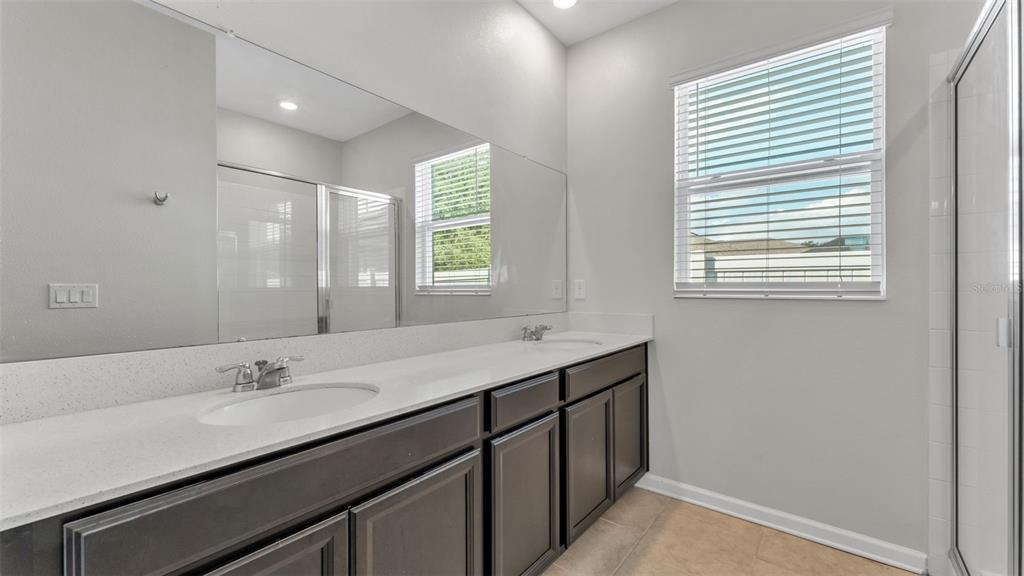 244 Pershing Street Bartow, FL 33830 - Photo 18 of 32 a bathroom with a sink double vanity and a shower