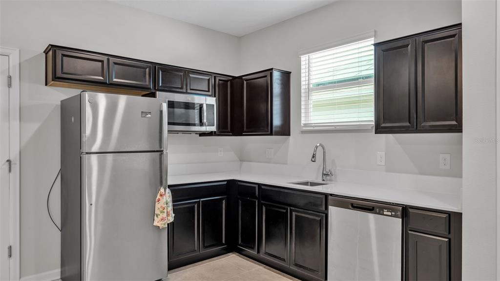 244 Pershing Street Bartow, FL 33830 - Photo 22 of 32 a kitchen with stainless steel appliances granite countertop a refrigerator and a sink