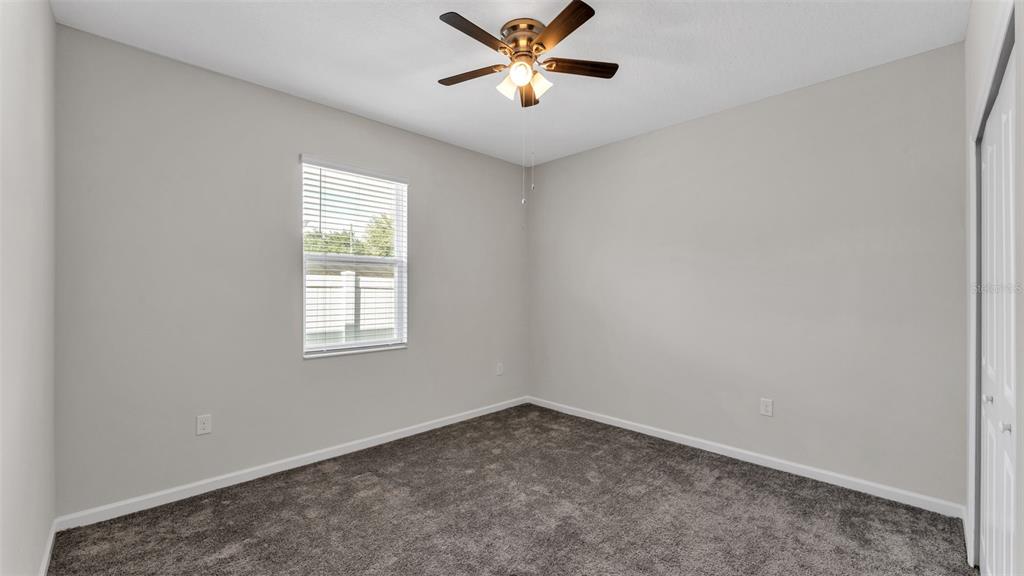 244 Pershing Street Bartow, FL 33830 - Photo 24 of 32 an empty room with a window and a fan