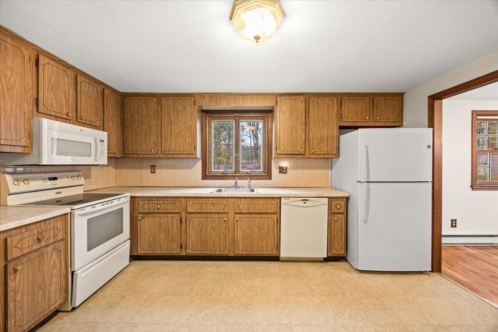 37 Woodlock Road Hingham, MA 02043 - Photo 13 of 34 a kitchen with a refrigerator sink and cabinets