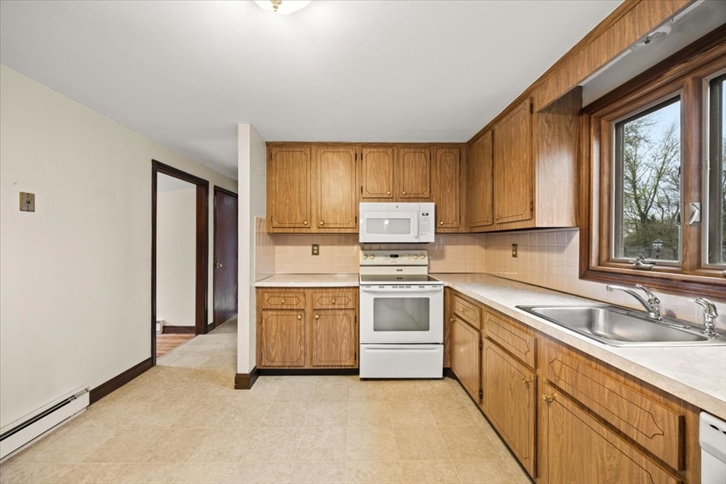 37 Woodlock Road Hingham, MA 02043 - Photo 15 of 34 a kitchen with white cabinets and white appliances
