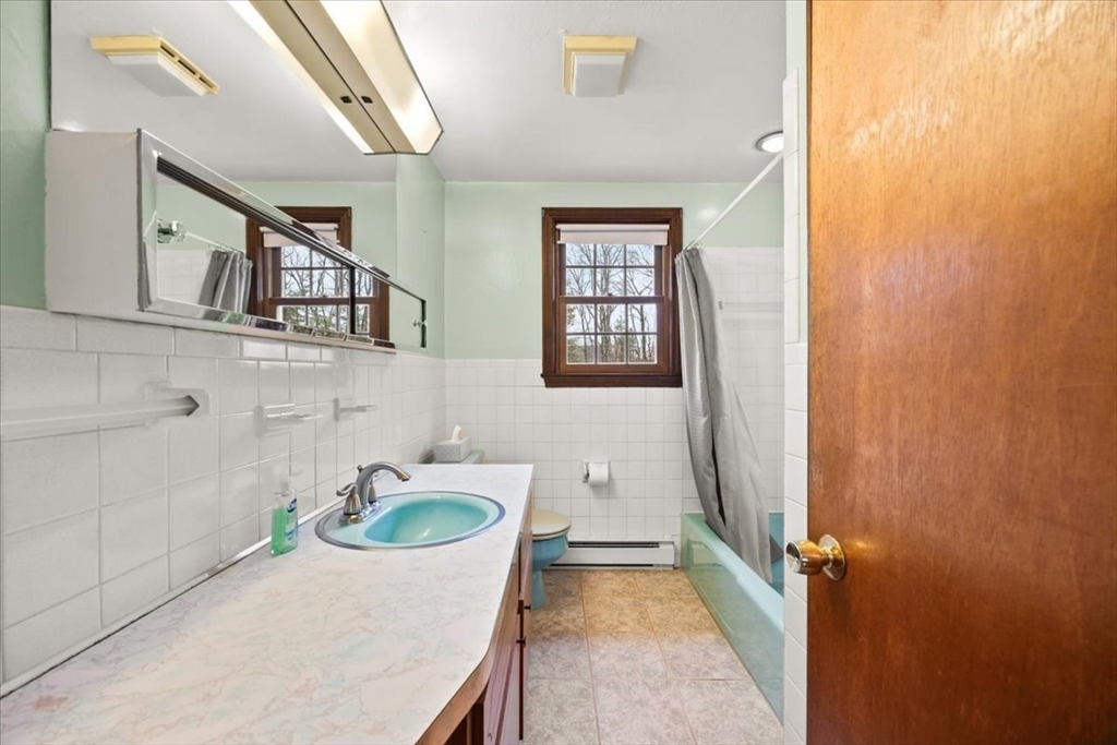 37 Woodlock Road Hingham, MA 02043 - Photo 20 of 34 a bathroom with a tub sink and mirror
