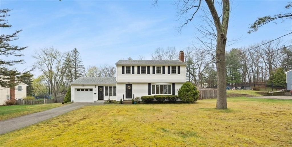 37 Woodlock Road Hingham, MA 02043 - Photo 2 of 34 a front view of a house with a yard table and chairs